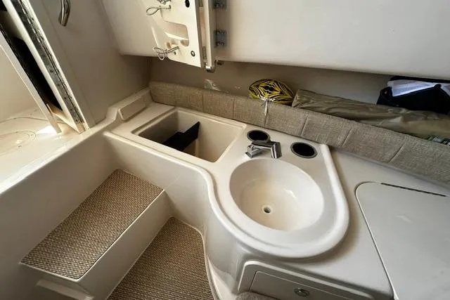 Slide: The Image of Interior of 2025 Grady-White Gulfstream 232 boat featuring a compact sink and seating area. - 38