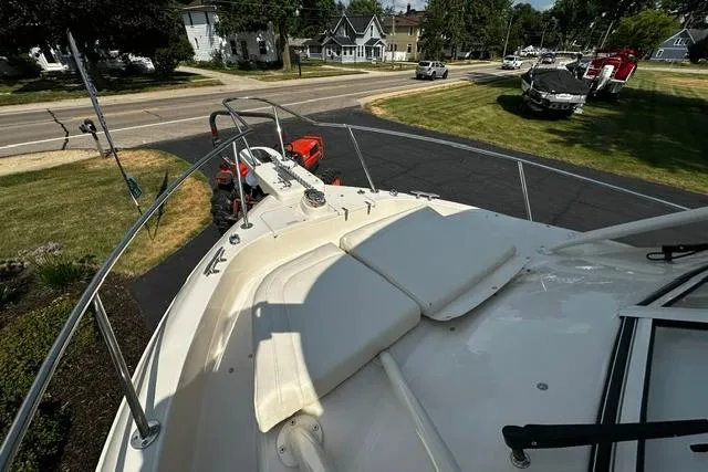 Slide: The Image of 2025 Grady-White Gulfstream 232 boat deck with cushioned seating, parked in a driveway. - 43