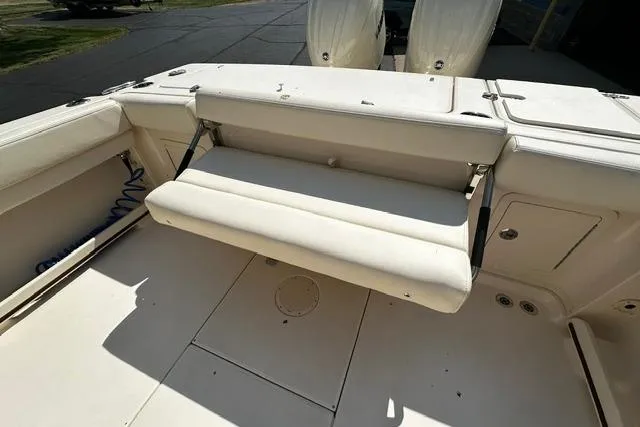 Slide: The Image of 2025 Grady-White Gulfstream 232 boat with foldable seating and spacious deck area. - 17