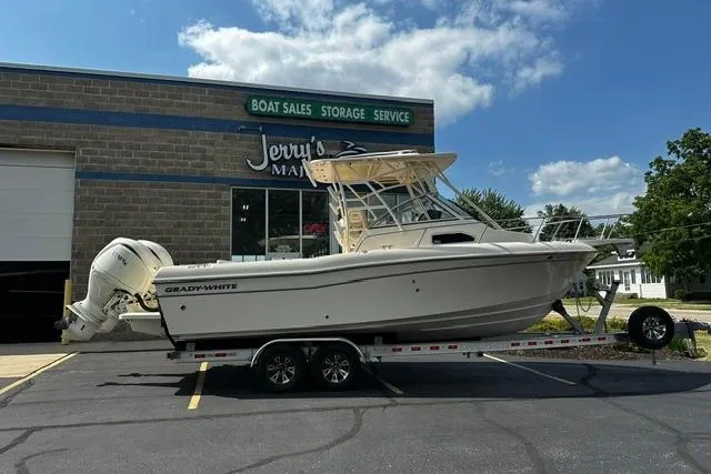 Slide: The Image of 2025 Grady-White Gulfstream 232 boat on trailer outside dealership. - 1