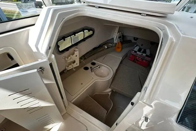 Slide: The Image of 2025 Grady-White Gulfstream 232 cabin interior with seating and storage. - 36