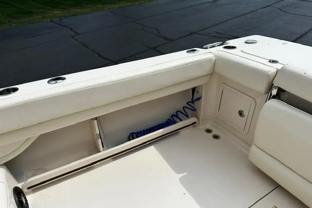 Slide: The Image of 2025 Grady-White Gulfstream 232 boat interior with white seating and storage compartments. - 15