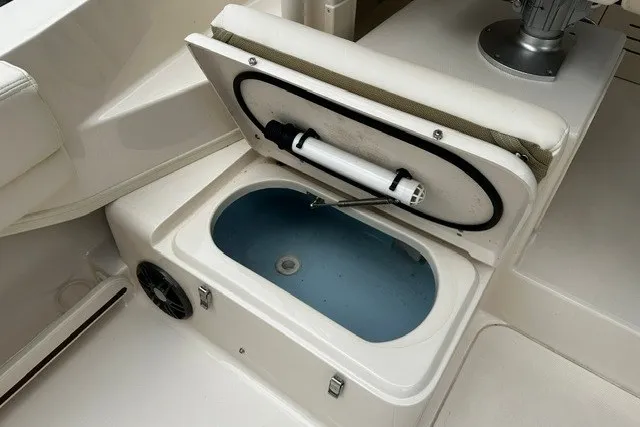 Slide: The Image of Livewell compartment on 2025 Grady-White Gulfstream 232 boat, featuring a clean, white interior. - 23