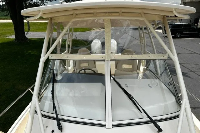 Slide: The Image of 2025 Grady-White Gulfstream 232 boat with windshield and seating, docked outdoors. - 50