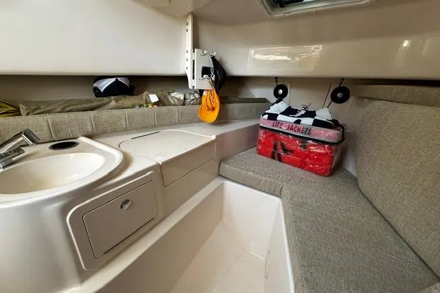 Slide: The Image of Interior of 2025 Grady-White Gulfstream 232 boat with sink, seating, and life jackets. - 42