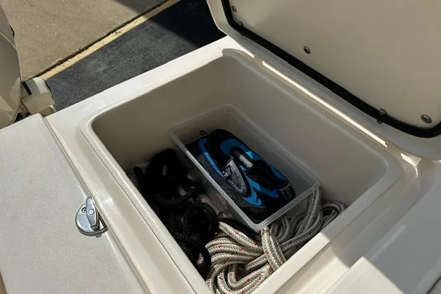 Slide: The Image of Storage compartment on 2025 Grady-White Gulfstream 232 boat with ropes and gear. - 21