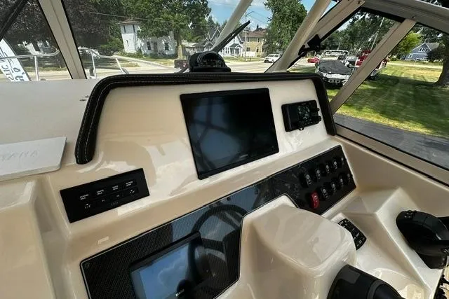 Slide: The Image of 2025 Grady-White Gulfstream 232 boat dashboard with modern controls and navigation screens. - 27