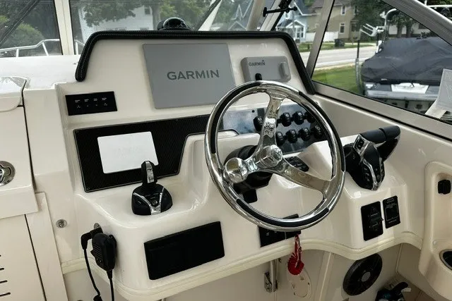 Slide: The Image of 2025 Grady-White Gulfstream 232 boat dashboard with Garmin navigation system. - 27