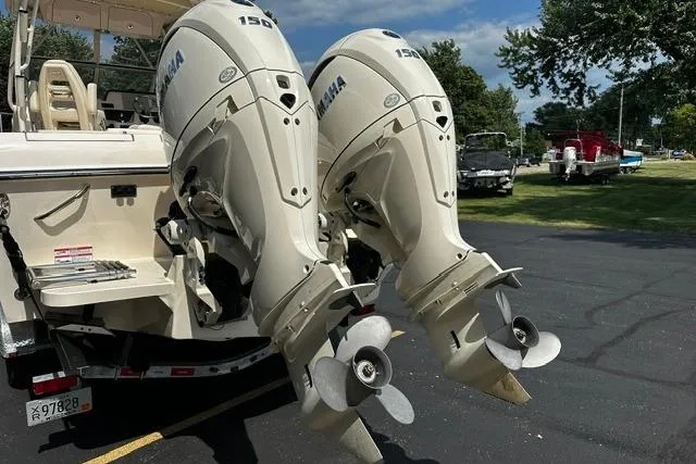 Slide: The Image of Twin Yamaha outboard motors on a 2025 Grady-White Gulfstream 232 boat, parked outdoors. - 6