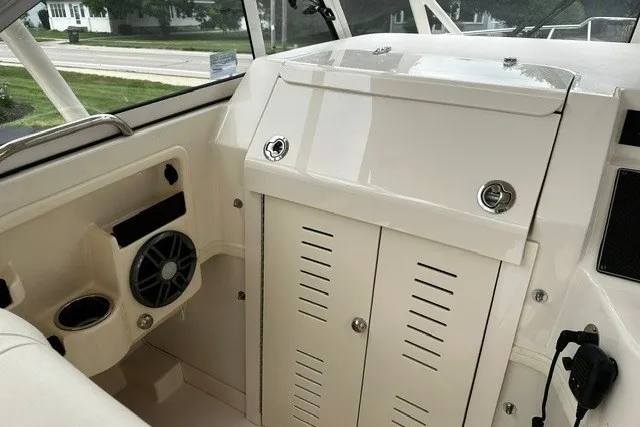 Slide: The Image of 2025 Grady-White Gulfstream 232 boat interior with storage and speaker system. - 43