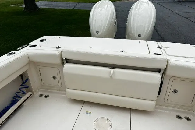Slide: The Image of 2025 Grady-White Gulfstream 232 boat interior with dual engines and seating area. - 15