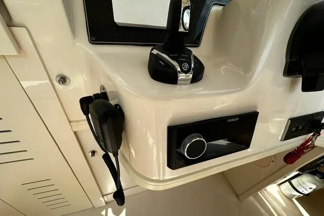 Slide: The Image of Control panel of 2025 Grady-White Gulfstream 232 boat with radio and throttle. - 30