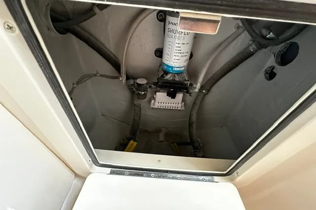 Slide: The Image of Bilge area of 2025 Grady-White Gulfstream 232 boat, featuring Shurflo pump and hoses. - 40