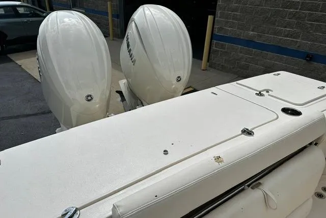 Slide: The Image of 2025 Grady-White Gulfstream 232 boat with dual outboard engines, parked outdoors. - 19