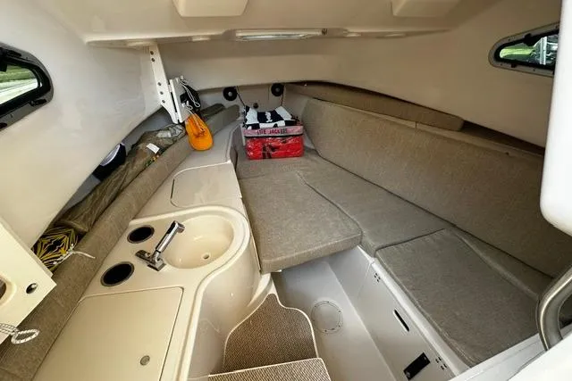 Slide: The Image of 2025 Grady-White Gulfstream 232 cabin interior with seating, sink, and storage. - 37