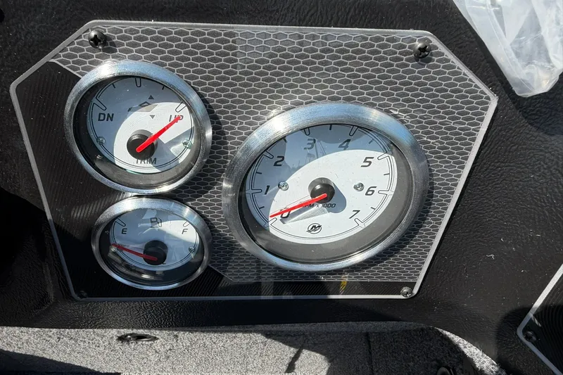 Slide: The Image of Dashboard gauges of 2027 Lund 1875 Impact XS Sport boat, featuring trim and fuel indicators. - 18
