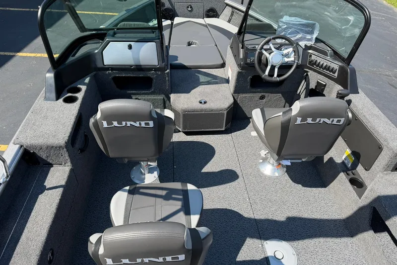 Slide: The Image of 2027 Lund 1875 Impact XS Sport boat interior with seating and steering console. - 5