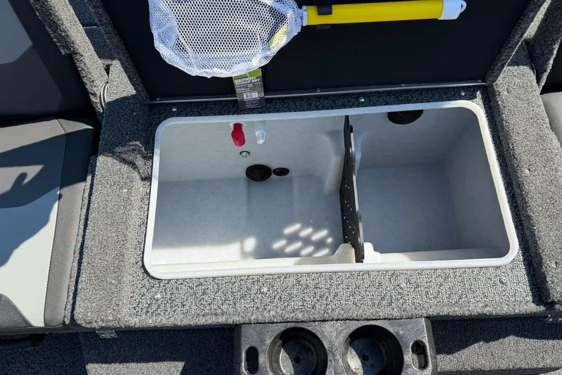 Slide: The Image of Livewell compartment in a 2027 Lund 1875 Impact XS Sport boat, featuring cup holders. - 9