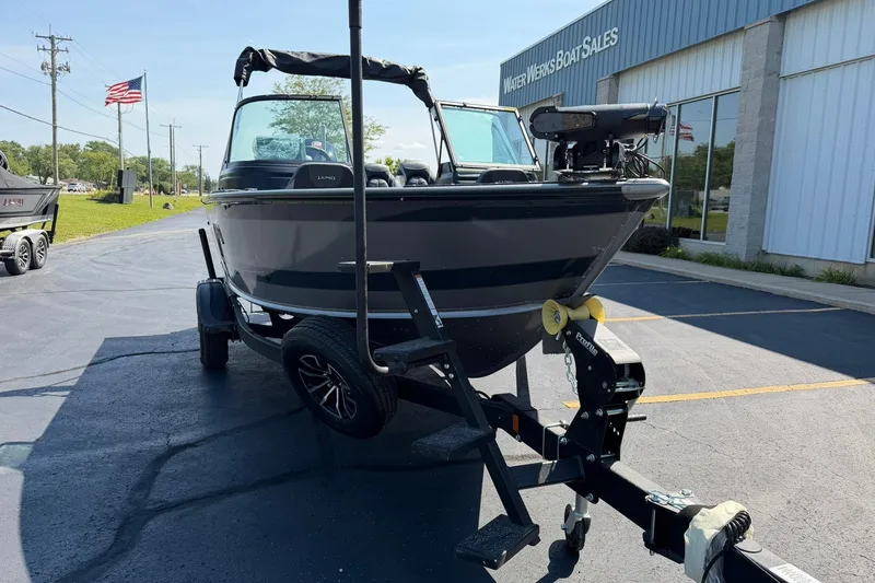 Slide: The Image of 2027 Lund 1875 Impact XS Sport boat on trailer at dealership. - 23