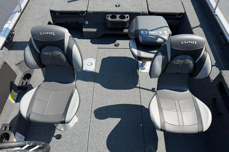 Slide: The Image of 2027 Lund 1875 Impact XS Sport boat interior with two cushioned seats and storage compartments. - 8