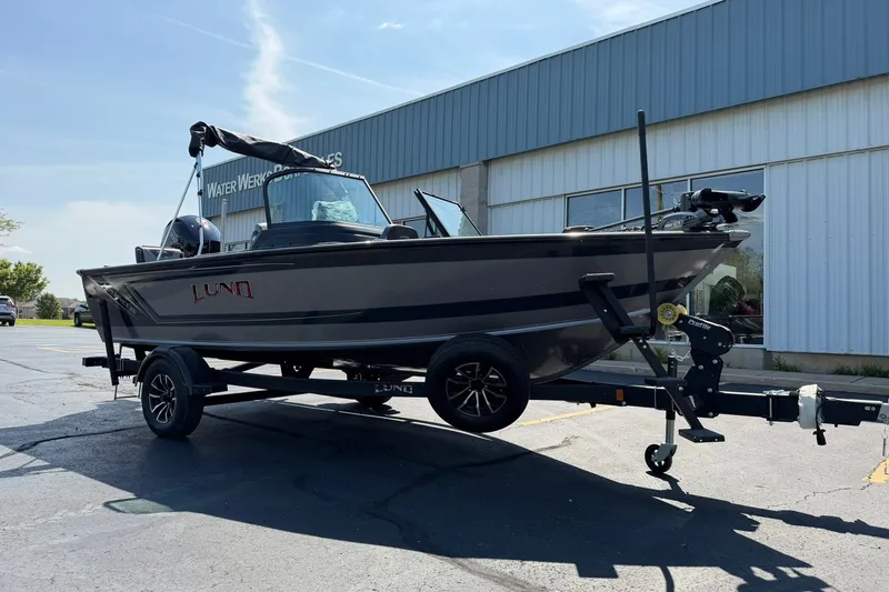 Slide: The Image of 2027 Lund 1875 Impact XS Sport boat on trailer outside dealership. - 4