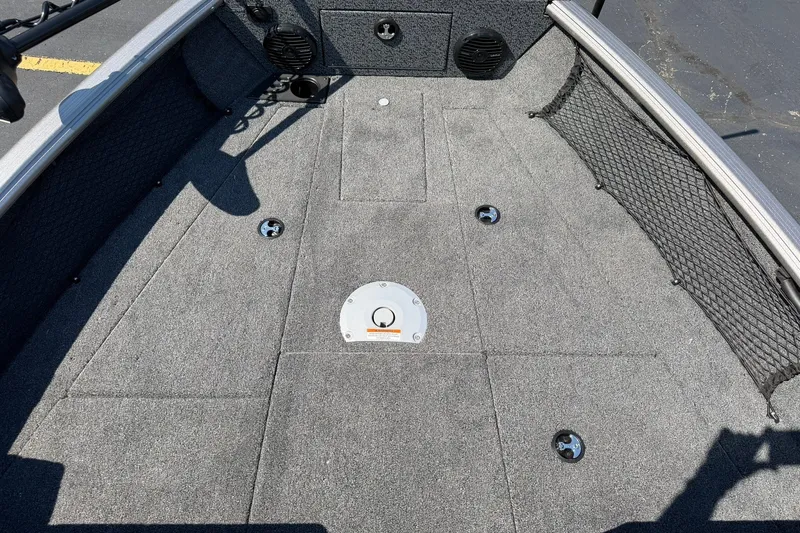 Slide: The Image of 2027 Lund 1875 Impact XS Sport boat interior with carpeted deck and storage compartments. - 13