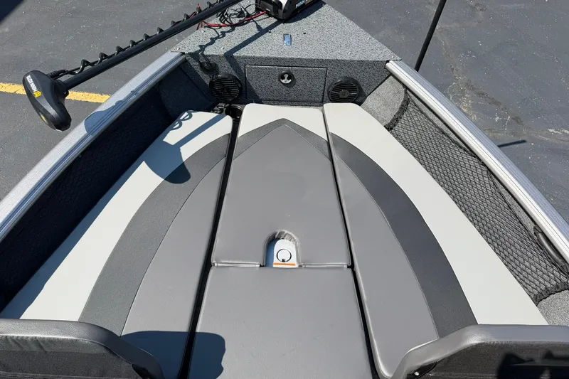 Slide: The Image of 2027 Lund 1875 Impact XS Sport boat interior with gray seating and trolling motor. - 12