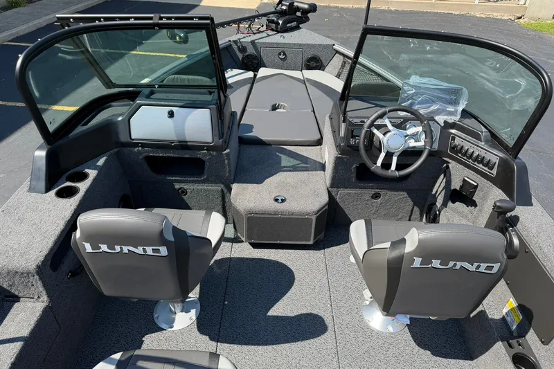 Slide: The Image of 2027 Lund 1875 Impact XS Sport boat interior with seating and steering wheel. - 6