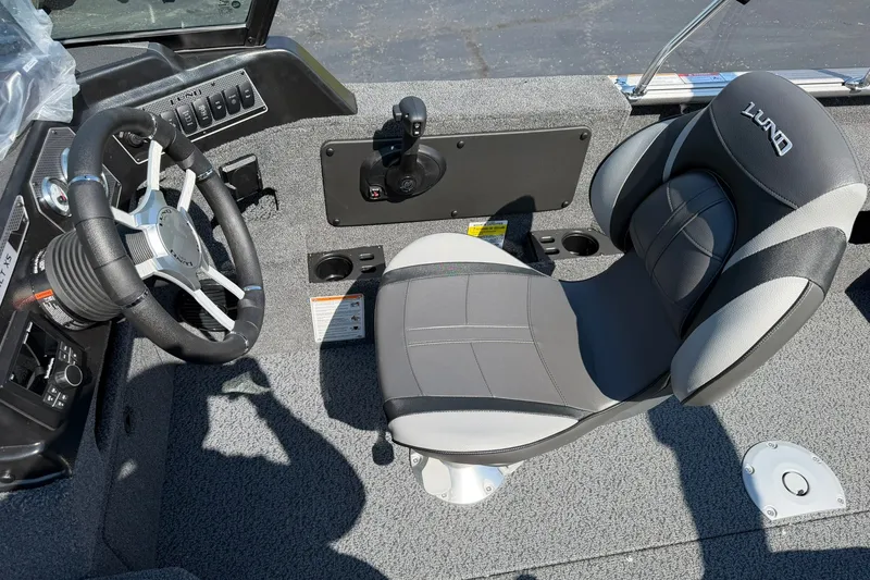 Slide: The Image of Interior of 2027 Lund 1875 Impact XS Sport boat with steering wheel and seat. - 15
