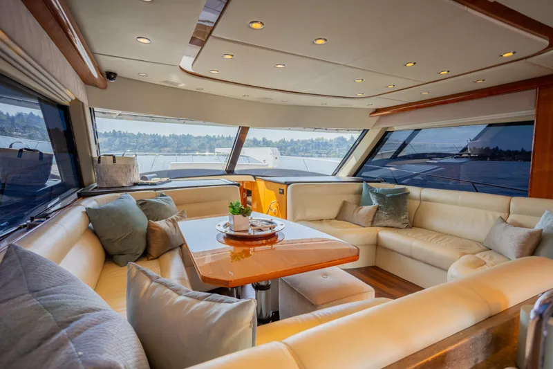 Slide: The Image of Luxurious interior of 2012 Riviera 33 Flybridge yacht with plush seating and panoramic windows. - 2
