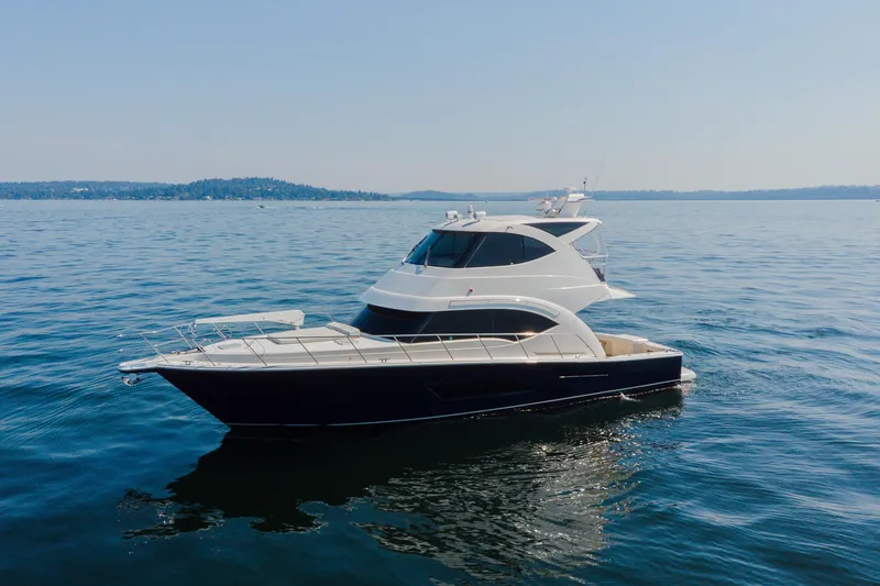 Slide: The Image of 2012 Riviera 33 Flybridge yacht cruising on calm blue waters. - 35