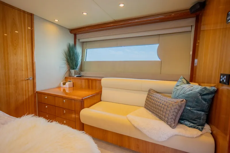 Slide: The Image of Luxurious interior of 2012 Riviera 33 Flybridge yacht with elegant wood finish and cozy seating. - 14
