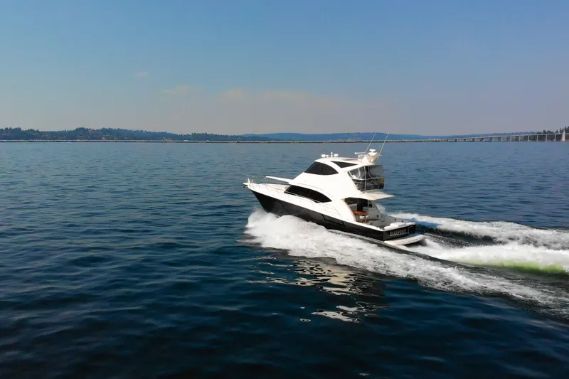 Slide: The Image of 2012 Riviera 33 Flybridge yacht cruising on open water under clear skies. - 41