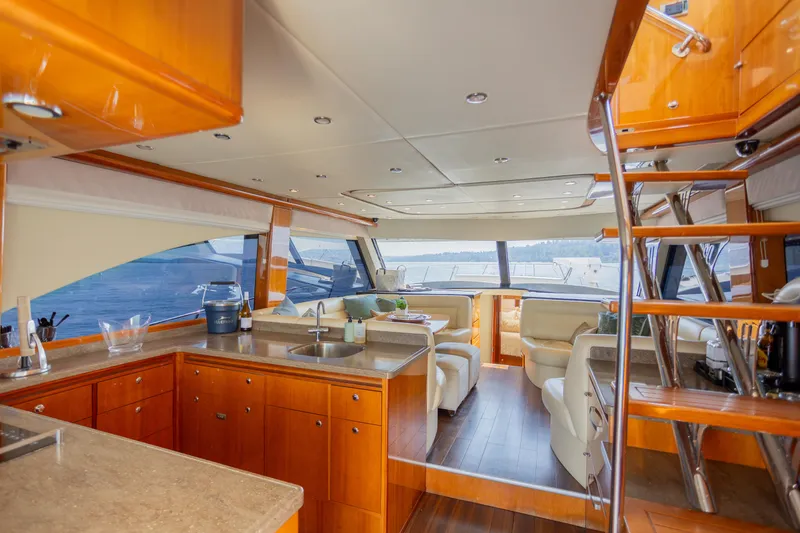Slide: The Image of Luxurious interior of 2012 Riviera 33 Flybridge yacht with modern kitchen and seating area. - 6