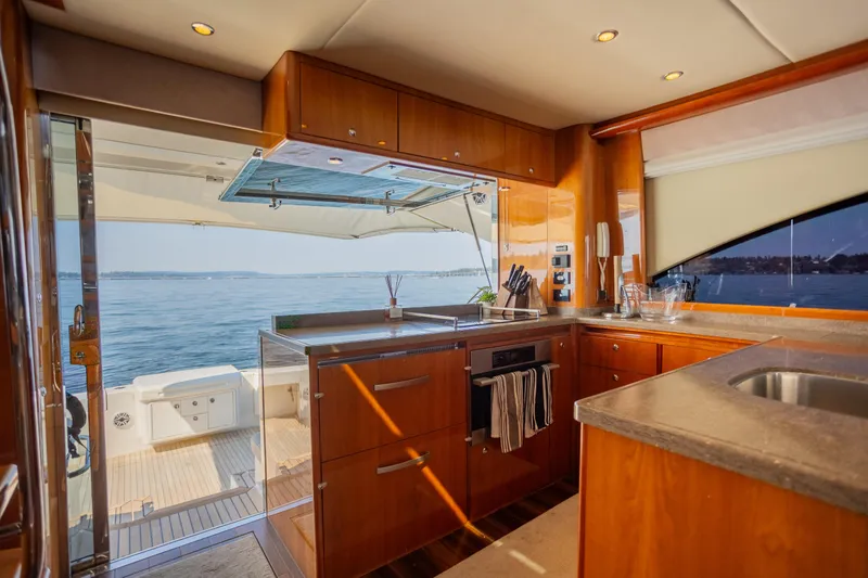 Slide: The Image of Luxurious interior of 2012 Riviera 33 Flybridge yacht with modern kitchen and ocean view. - 5