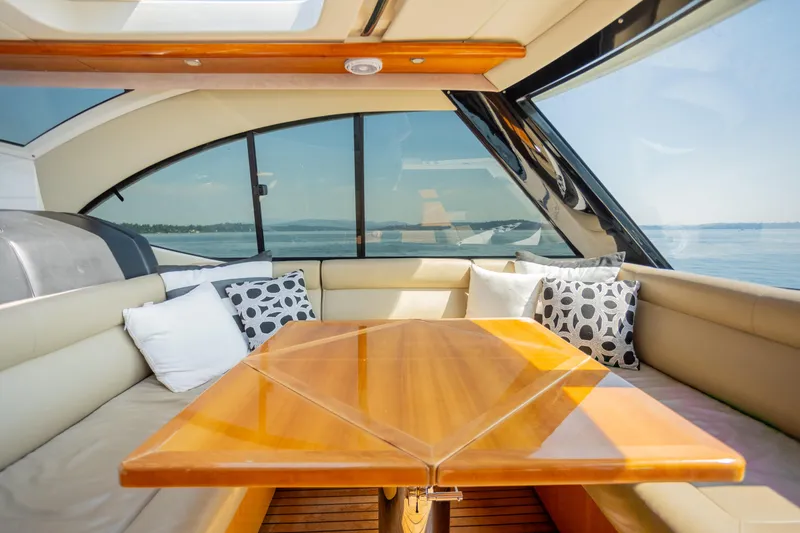 Slide: The Image of Luxurious interior of 2012 Riviera 33 Flybridge yacht with elegant seating and scenic views. - 21