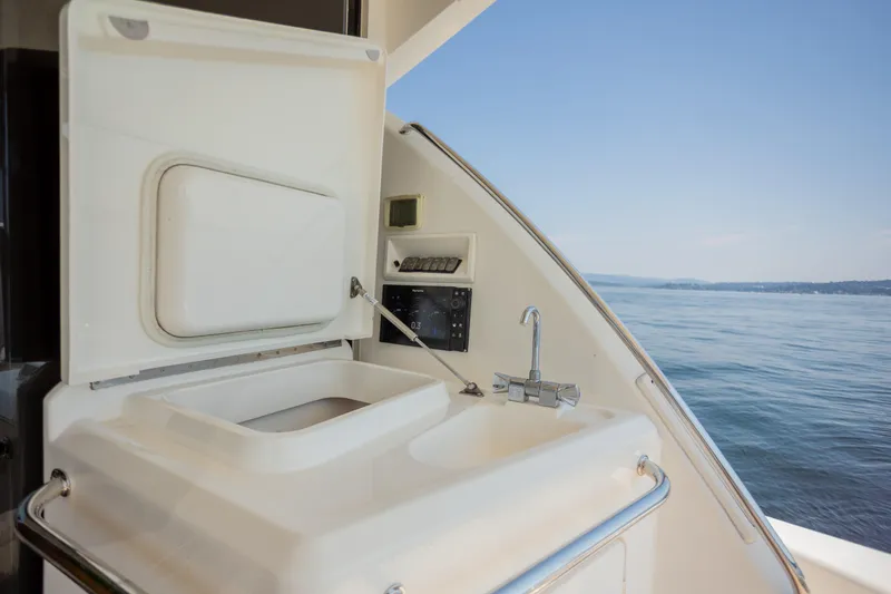 Slide: The Image of 2012 Riviera 33 Flybridge yacht sink area with ocean view. - 28