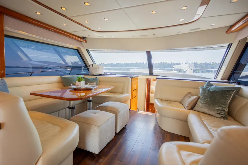 Slide: The Image of Luxurious interior of 2012 Riviera 33 Flybridge yacht with elegant seating and panoramic windows. - 3
