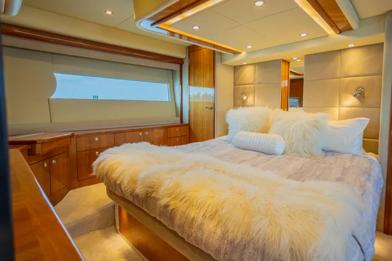 Slide: The Image of Luxurious bedroom interior of 2012 Riviera 33 Flybridge yacht with plush bedding. - 13