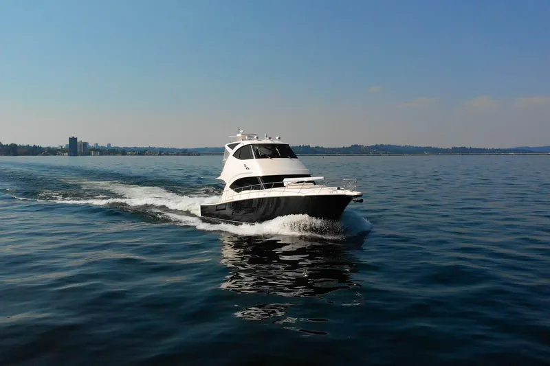 Slide: The Image of 2012 Riviera 33 Flybridge yacht cruising on open water under clear skies. - 40