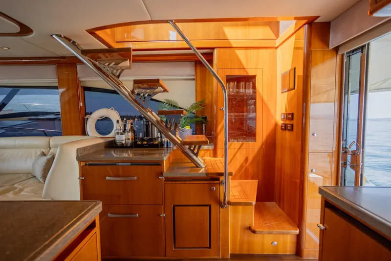 Slide: The Image of Luxurious interior of 2012 Riviera 33 Flybridge yacht with wooden finishes and modern amenities. - 7