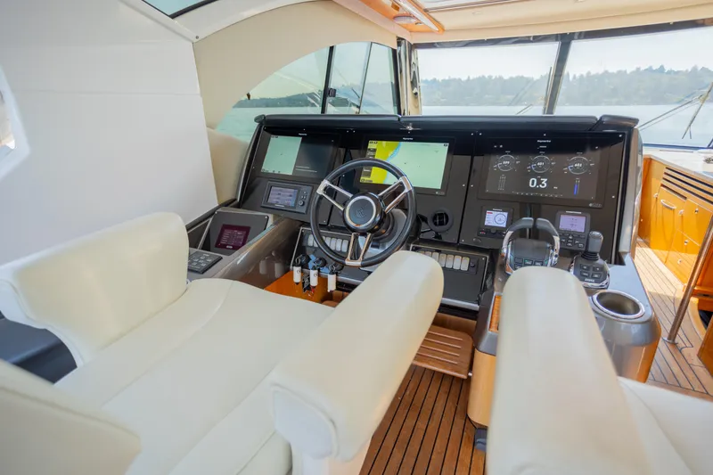Slide: The Image of Cockpit of 2012 Riviera 33 Flybridge yacht with modern navigation controls. - 23