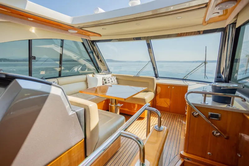 Slide: The Image of Luxurious interior of 2012 Riviera 33 Flybridge yacht with panoramic windows and elegant seating. - 20