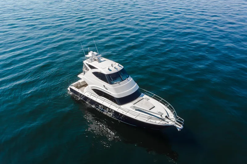 Slide: The Image of 2012 Riviera 33 Flybridge yacht cruising on calm blue waters. - 42