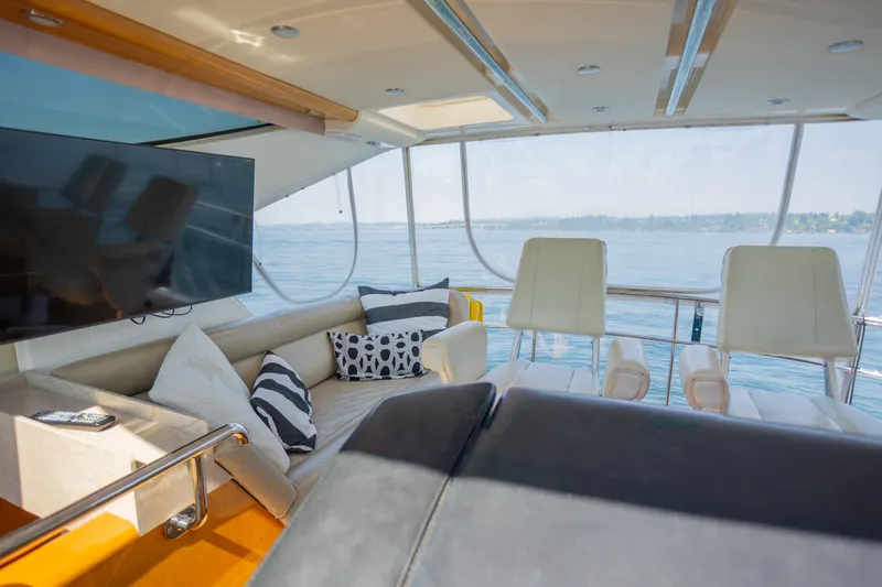Slide: The Image of Luxurious interior of 2012 Riviera 33 Flybridge yacht with plush seating and scenic ocean view. - 22