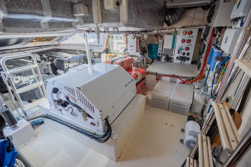 Slide: The Image of Engine room of 2012 Riviera 33 Flybridge yacht, showcasing equipment and wiring. - 34