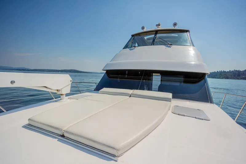 Slide: The Image of 2012 Riviera 33 Flybridge yacht on calm water, featuring spacious deck and sleek design. - 31