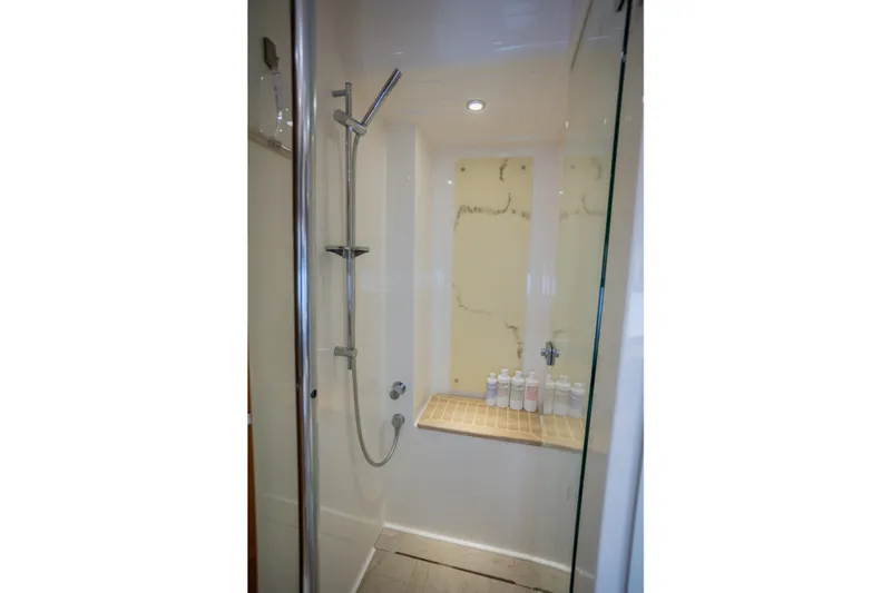 Slide: The Image of Shower area in 2012 Riviera 33 Flybridge yacht with modern fixtures and toiletries. - 16