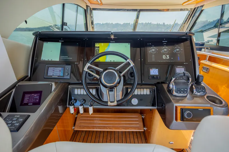 Slide: The Image of Cockpit of 2012 Riviera 33 Flybridge yacht with advanced navigation controls and displays. - 24