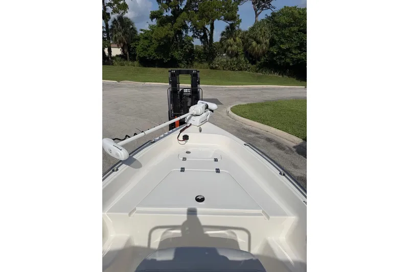 Slide: The Image of 2024 Key West 1720 Center Console boat with trolling motor, parked on a sunny day. - 10